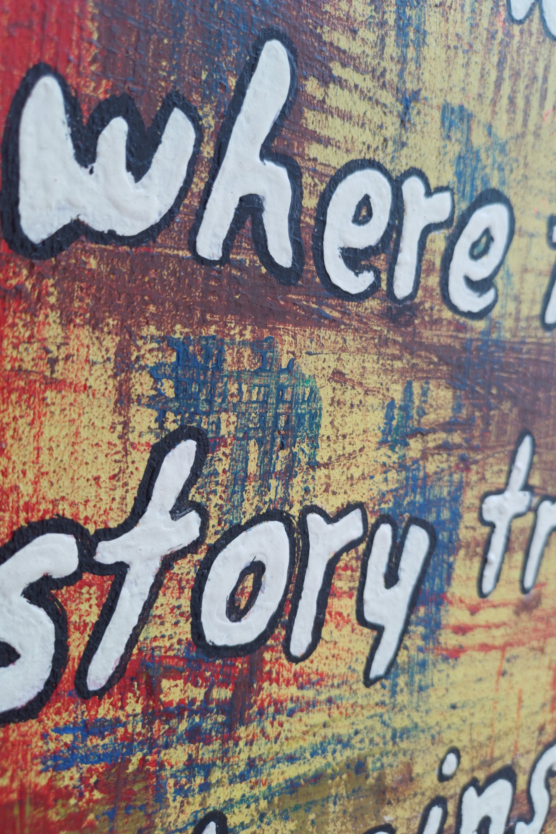 Close-up of lettering and bold textures on painting: ‘is where the story truly begins."