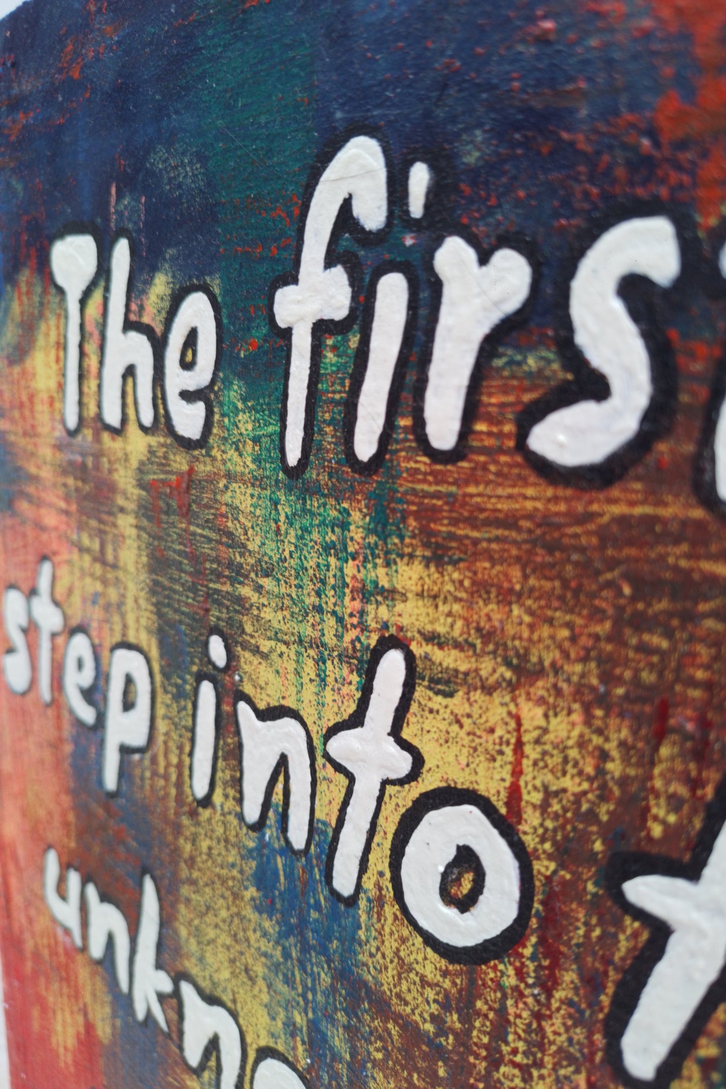 “Close-up detail of textured brushstrokes on expressionism painting with quote: ‘The first step into the unknown."