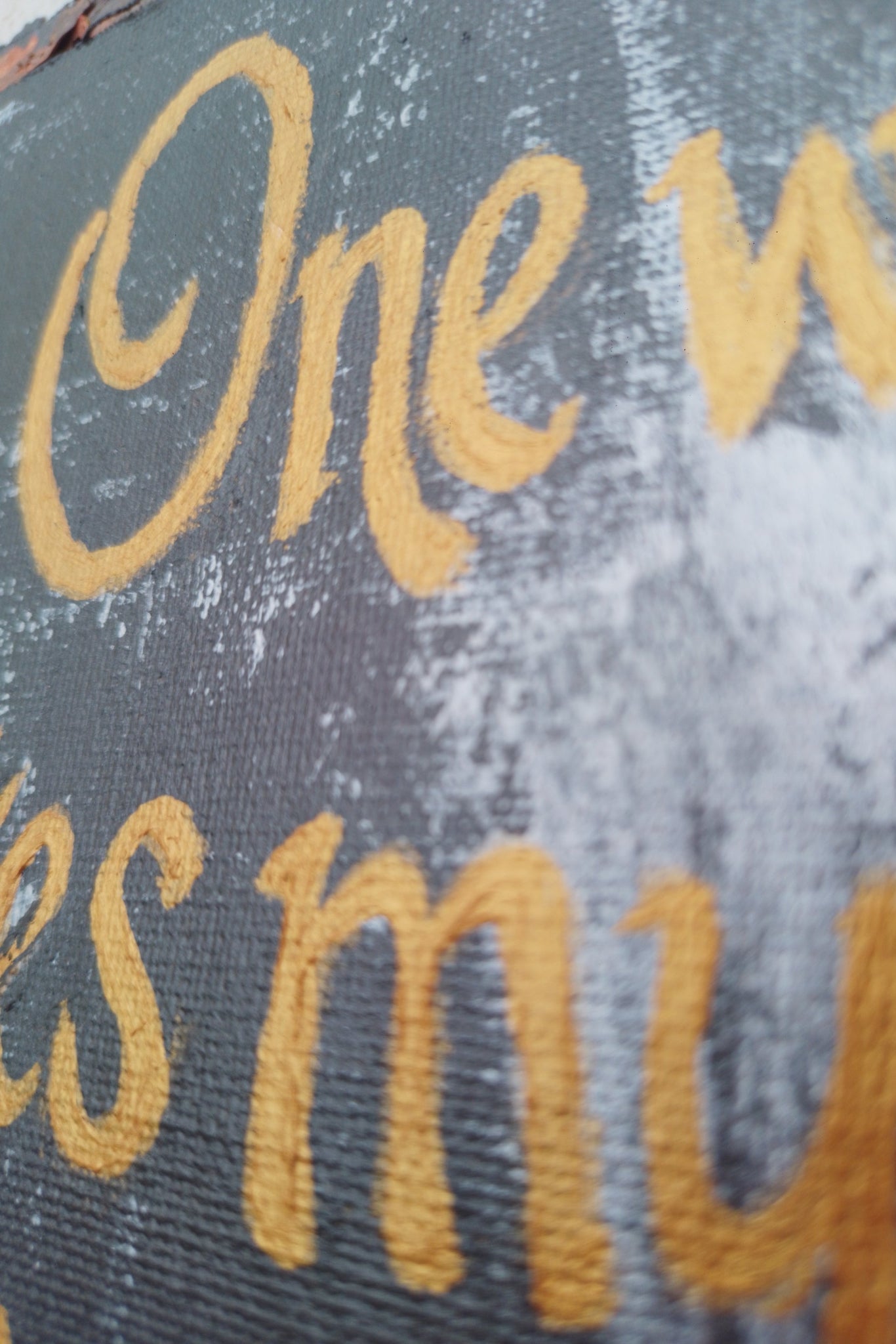Acrylic painting of Text with golden letters on a textured Gray background