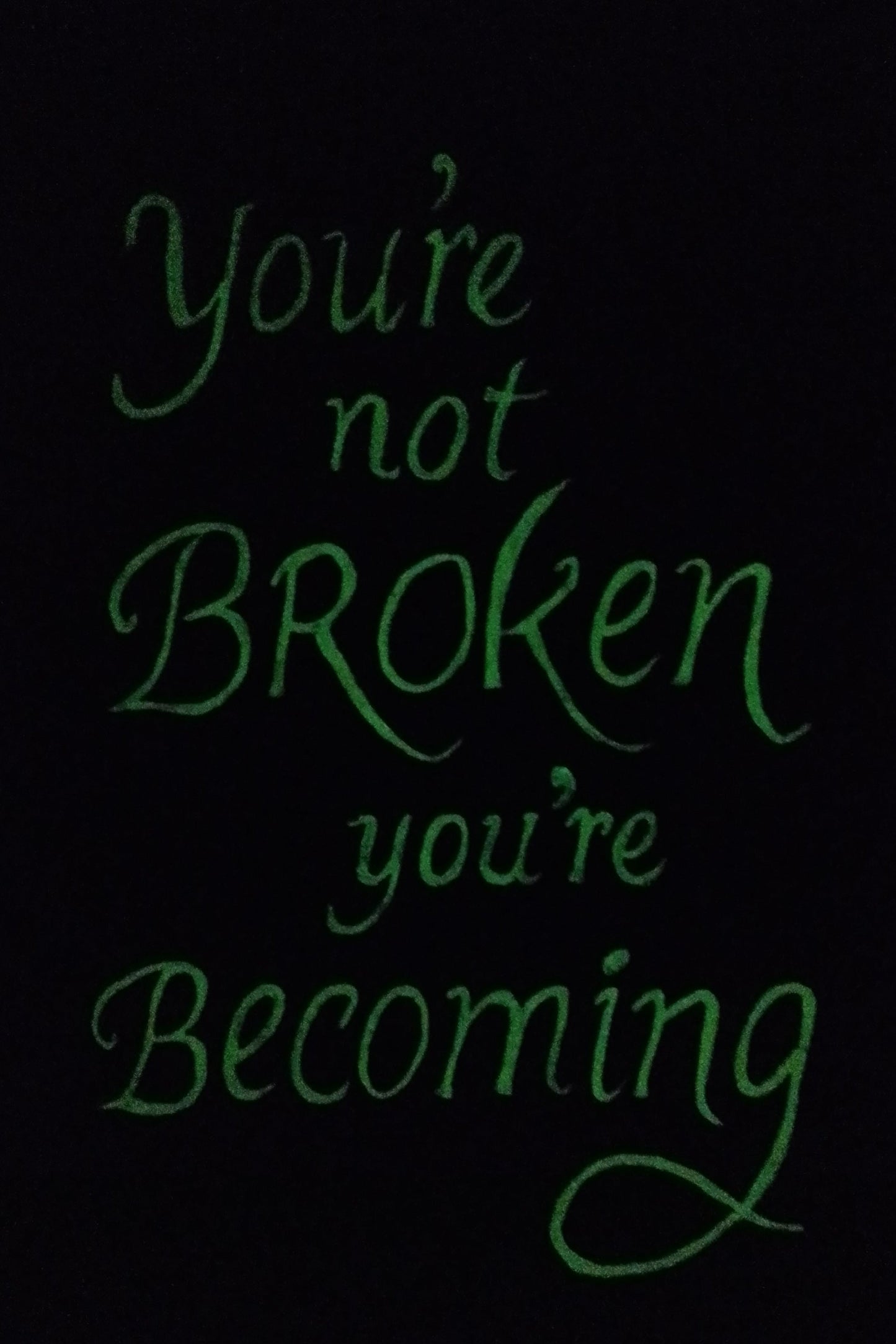 “Glow-in-the-dark version of abstract painting with quote: ‘You’re not broken, you’re becoming.’ Letters and golden cracks softly glowing.”